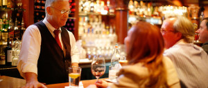 Image of bartender with guests