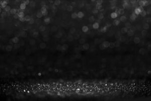 Black friday bokeh background. Elegant dark blur layout design. Silver and black glitter place on table with spotlight. Luxury abstract banner with copyspace.